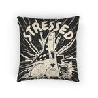 Pillow with cartoon character and 'STRESSED' text on a black background